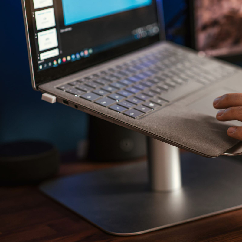 Typing on a laptop raised on a stand