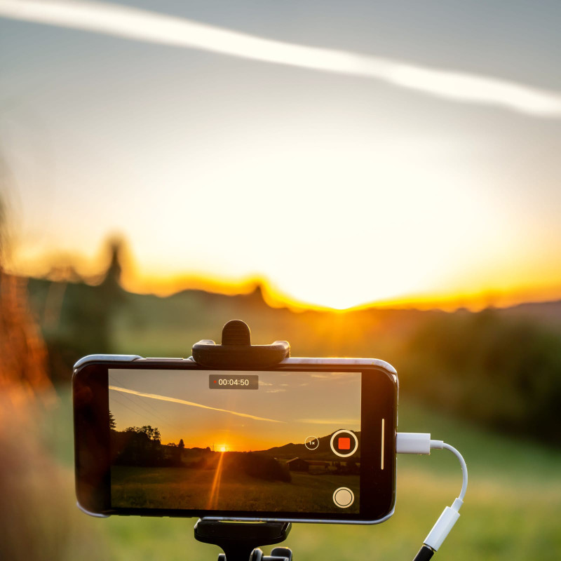 Filming a sunset with a selfie stick