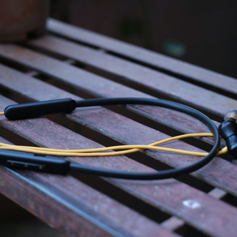 Neckband earphones on a bench