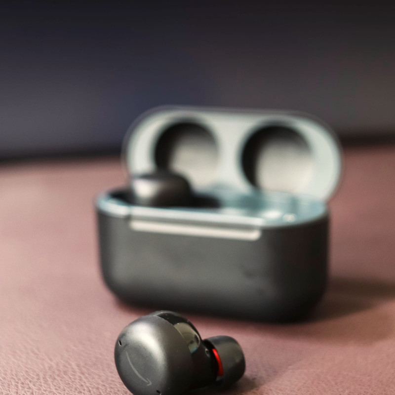 Graphite earbuds in an open case